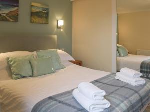 En eller flere senge i et værelse på The Old Coach House + 12 billeder