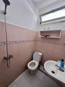 a bathroom with a toilet and a sink at TISLIT Surf Taghazout in Taghazout