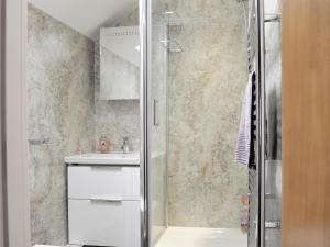 a bathroom with a shower and a sink at 9 Howrah's Court in Keswick +2 photos