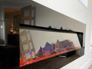 a fireplace in a living room with flames in it at 4 Mote View-Uk37497 in Sandhead +19 photos