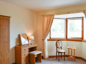 a room with a chair and a mirror and a window at Peace in Whauphill