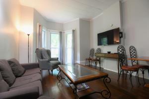 a living room with a couch and a table at Fully Remodeled, Charming Victorian Home in Rochester