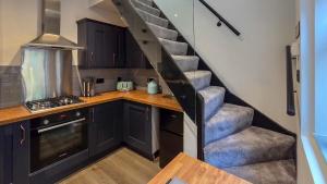 a kitchen with a spiral staircase in a house at O & A Retreat in York