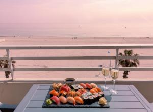 a plate of food on a table next to a beach at T3 Vue mer à couper le souffle in Canet-en-Roussillon