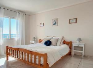 a bedroom with a large bed with a view of the ocean at T3 Vue mer à couper le souffle in Canet-en-Roussillon +36 photos