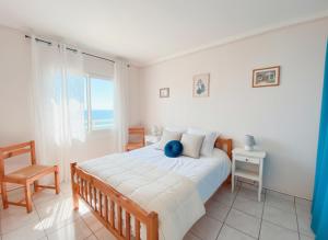 a bedroom with a bed with a blue ball on it at T3 Vue mer à couper le souffle in Canet-en-Roussillon