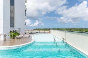 a swimming pool on the balcony of a building at BHS Flat a beira mar 2105 in Recife