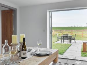 a dining room with a table with wine glasses at The Foundary - Uk36319 in Whitchurch