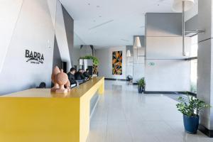 a lobby of a restaurant with people sitting at a counter at BHS Flat a beira mar 2105 in Recife +50 photos