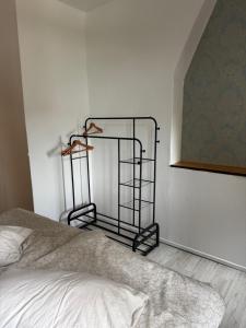 a bedroom with a bed and a shelf on the wall at Kaminzimmer in Trebbin