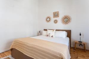 a bedroom with a bed and two mirrors on the wall at Brisa do Sul in Porches