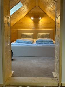 a bedroom with a bed in a wooden cabin at RRR Apartmány 4 in Bojnice