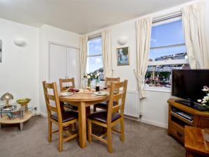 ブリクサムにある2 Fishermans Loftのテーブルと椅子とテレビのあるダイニングルーム