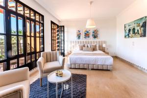a bedroom with a bed and a couch and a table at MVIEW Villas in Marrakech