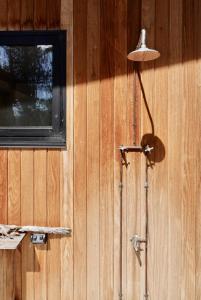 a floor lamp next to a building with a window at The Lookout House at Pirates Bay in Eaglehawk Neck +57 photos