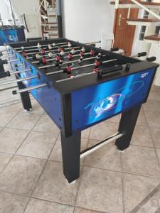 a blue and black foosball table in a room at Erdőparty Vendégház in Tápiószecső