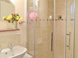 a shower with a glass door next to a sink at Byre Cottage - 29410 in Elmsted +6 photos