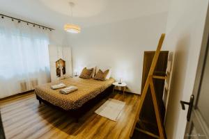 a bedroom with a bed with two pillows on it at Appartement face aux thermes de vals WIFI-Parking gratuit in Vals-les-Bains