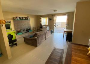 a living room with a couch and a fireplace at Iane Raquel Bezerra Barbosa in Tamandaré