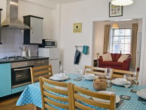 a kitchen and dining room with a table and chairs at Rose Cottage in Low Bradley