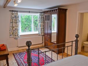 a bedroom with a bed and a window at The Old Stables in Cley next the Sea
