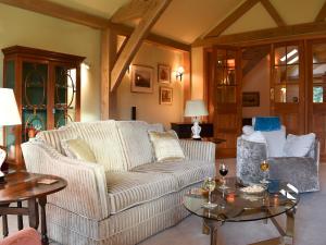 a living room with a couch and a table at Mill Of Burncrook in Glenlivet