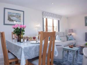 a living room with a table and a couch at The Linhay in Durleigh