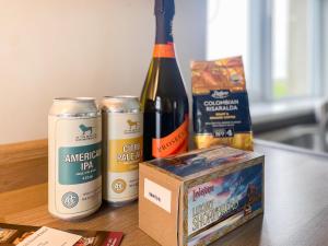 a bottle of wine and a box on a table at Six The Square - Uk48869 in Belford