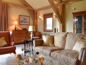 a living room with a couch and a table at Mill Of Burncrook in Glenlivet