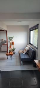 a living room with a couch and a window at Refúgio das Regadinhas in Santa Cruz