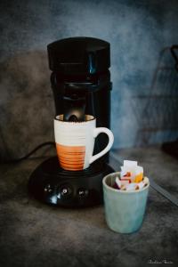 a coffee maker with a cup on top of it at Le Coeur Ardéchois in Vals-les-Bains +5 photos