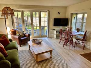 a living room with a couch and a table at The Barn at The Manor in Cole, Bruton in Cole