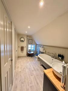 a large bathroom with a tub and a sink at The Barn at The Manor in Cole, Bruton in Cole +63 photos