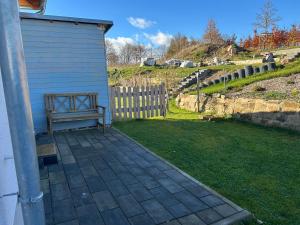 a bench sitting on the side of a house at Well-being in Eifel in Nettersheim