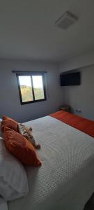 a bedroom with a bed with two pillows and a window at Refúgio das Regadinhas in Santa Cruz +10 photos