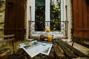 a table with two glasses of orange juice on a porch at La bogue in Vals-les-Bains
