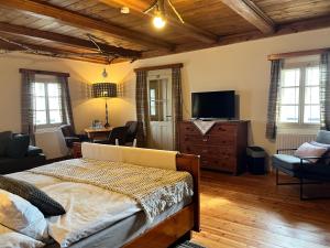 a bedroom with a bed and a flat screen tv at Landgasthof Marhube in Baldramsdorf +20 photos