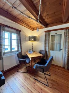 a dining room with a wooden table and chairs at Landgasthof Marhube in Baldramsdorf