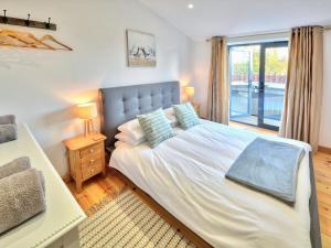 a bedroom with a large bed and a window at Dornfelder - Ukc3209 in Newbridge