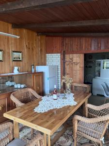 a dining room with a wooden table and chairs at Kuća za odmor Sremac in Apatin