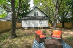 two chairs and a table in front of a house at My house your house in Fort Smith