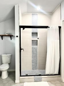 a bathroom with a shower with a toilet at My house your house in Fort Smith +27 photos