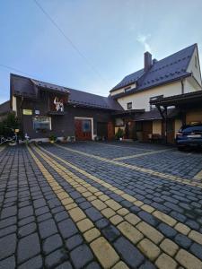 a cobblestone driveway in front of a building at Pod Cisowcem in Sromowce Wyżne