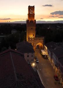 a building with a clock tower in a city at Casa Sorgata in Noale +36 photos