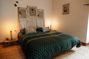 a bedroom with a bed and an open door at Le Logis du Vieux Donjon in Châteaumur