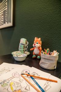 a table with pencils and a drawing of a bear at ACHAT Hotel Leipzig Messe in Leipzig
