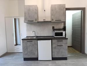 a kitchen with a sink and a microwave at MT-Apartments in Bollate +20 photos