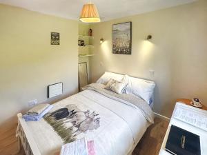 a small bedroom with a bed and a laptop at The Nest - Uk46879 in Woodbury