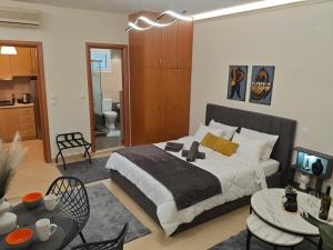 a bedroom with a bed and a living room at Kerkétio guesthouse in Tríkala