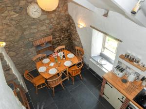 une salle à manger avec une table et des chaises en bois dans l'établissement Ffynnonddewi Farmhouse - Qc1535, à Llanhowell 18 autres photos